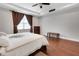 Spacious bedroom with tray ceilings, wood floors, a ceiling fan, and plenty of natural light at 1005 Salamanca Pl, Davenport, FL 33837