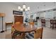 Bright dining area showcases a dining table, chandelier, and an open view of the kitchen and living spaces at 1005 Salamanca Pl, Davenport, FL 33837