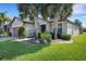 Charming single-story home with well-manicured lawn, stone accents, and beautiful palm trees at 1005 Salamanca Pl, Davenport, FL 33837