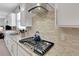 Close-up of kitchen's gas range, stainless steel appliances, and subway tile backsplash at 1005 Salamanca Pl, Davenport, FL 33837