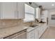 Galley kitchen boasts stainless steel appliances, granite countertops, tile backsplash and ample cabinetry at 1005 Salamanca Pl, Davenport, FL 33837
