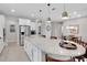 Bright kitchen features a large island, stainless steel appliances, granite countertops, and pendant lighting at 1005 Salamanca Pl, Davenport, FL 33837