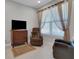 Comfortable living room featuring a plush recliner, TV, and soft lighting at 1005 Salamanca Pl, Davenport, FL 33837