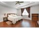 Relaxing main bedroom features hardwood floors, a tray ceiling, a large window, and a cozy seating area at 1005 Salamanca Pl, Davenport, FL 33837