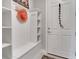 Well-organized mudroom with a built-in bench, hooks, and storage shelves for added convenience at 1005 Salamanca Pl, Davenport, FL 33837