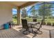 Enclosed patio with dining set offers a relaxing outdoor space with views of the landscaped backyard at 1005 Salamanca Pl, Davenport, FL 33837