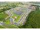 This aerial shot captures a community with a central lake and pool, surrounded by lush greenery and homes at 1039 Tourmaline Dr, Kissimmee, FL 34746