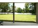 A beautiful backyard view from the patio, featuring lush grass, trees, and a white fence for added privacy at 1039 Tourmaline Dr, Kissimmee, FL 34746