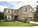 Two-story home with a well-manicured lawn and a two-car garage, exuding curb appeal and modern comfort at 1039 Tourmaline Dr, Kissimmee, FL 34746