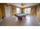 Inviting game room featuring a billiard table and ample natural light, perfect for entertainment and relaxation in the community at 1039 Tourmaline Dr, Kissimmee, FL 34746