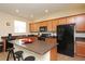 Well-equipped kitchen features a center island and black appliances at 1039 Tourmaline Dr, Kissimmee, FL 34746