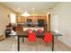 Bright kitchen with stainless steel appliances, a large island, and a dining table with colorful chairs at 1039 Tourmaline Dr, Kissimmee, FL 34746