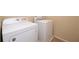 A laundry room showcasing a Whirlpool dryer and washing machine with ceramic tile flooring at 1039 Tourmaline Dr, Kissimmee, FL 34746