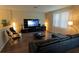 Modern living room showcasing a sleek black entertainment center, comfortable seating, and ample natural light at 1039 Tourmaline Dr, Kissimmee, FL 34746