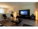 Open-concept living room featuring a modern entertainment center, stylish seating, and contemporary decor at 1039 Tourmaline Dr, Kissimmee, FL 34746