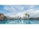 Large community pool surrounded by palms and beautiful Florida sky at 1039 Tourmaline Dr, Kissimmee, FL 34746