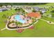 Aerial shot of a community pool and recreation center, surrounded by lush landscaping and walking trails at 1039 Tourmaline Dr, Kissimmee, FL 34746