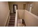 Hallway staircase with wood floors, white risers, and a large mirror at 1039 Tourmaline Dr, Kissimmee, FL 34746