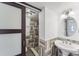 Stylish bathroom featuring a walk-in shower, a modern sink with tile accents, and a sliding glass door at 1067 Ronlin St, Haines City, FL 33844