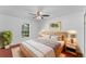 Serene bedroom with a fan, natural light, neutral tones, and hardwood floors for a tranquil retreat at 1067 Ronlin St, Haines City, FL 33844