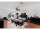 Modern bedroom featuring dark furniture, wood floors, and natural light at 1067 Ronlin St, Haines City, FL 33844