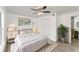 This bedroom features white walls, a ceiling fan, and an ensuite bathroom at 1067 Ronlin St, Haines City, FL 33844