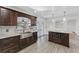 Well-lit kitchen featuring a center island with stone counters, and a view through the glass doors at 1067 Ronlin St, Haines City, FL 33844