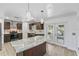 Open kitchen with granite counters, center island, stainless appliances, and glass doors at 1067 Ronlin St, Haines City, FL 33844