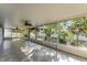 A large enclosed patio with tiled floors, multiple ceiling fans and backyard access at 1067 Ronlin St, Haines City, FL 33844