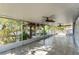 A large enclosed patio with tiled floors and multiple ceiling fans at 1067 Ronlin St, Haines City, FL 33844