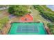 An aerial view of a tennis court and fenced in playground on a landscaped community lot at 1119 Mariner Cay Dr, Haines City, FL 33844