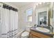 Bright bathroom with a shower-tub combo and framed mirror above the vanity at 1119 Mariner Cay Dr, Haines City, FL 33844