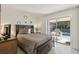 Bedroom with queen bed and sliding glass doors leading to the screened-in pool area at 1119 Mariner Cay Dr, Haines City, FL 33844