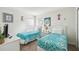 Bright bedroom featuring twin beds with turquoise patterned bedspreads and playful Mickey Mouse wall decor at 1119 Mariner Cay Dr, Haines City, FL 33844