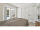 Bedroom with queen bed, closet and sliding glass doors leading to the screened-in pool area at 1119 Mariner Cay Dr, Haines City, FL 33844