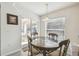 Bright dining area features a glass table, wood chairs, and a sliding glass door to the outdoor area at 1119 Mariner Cay Dr, Haines City, FL 33844