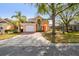 A charming two-story home with a two-car garage, a well-manicured lawn, and mature palm trees at 1119 Mariner Cay Dr, Haines City, FL 33844