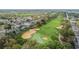 Aerial view of a lush green golf course surrounded by beautiful homes and mature trees at 1119 Mariner Cay Dr, Haines City, FL 33844