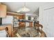 Bright eat-in kitchen featuring oak cabinets, white appliances, and views into the living room at 1119 Mariner Cay Dr, Haines City, FL 33844