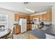Bright kitchen with wood cabinets, laminate countertops, and a full suite of appliances at 1119 Mariner Cay Dr, Haines City, FL 33844