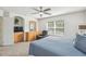 Inviting main bedroom featuring dresser, mounted TV, and relaxing recliner at 1119 Mariner Cay Dr, Haines City, FL 33844