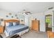 Comfortable main bedroom with ceiling fan, wood furniture, and natural light at 1119 Mariner Cay Dr, Haines City, FL 33844