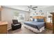 Comfortable main bedroom with ceiling fan, a plush bed, and natural light from the window at 1119 Mariner Cay Dr, Haines City, FL 33844