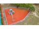Elevated view of a community playground featuring a slide and climbing bars with safety mulch and a fence at 1119 Mariner Cay Dr, Haines City, FL 33844