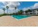Community pool surrounded by lush landscaping and palm trees under a bright sky at 1119 Mariner Cay Dr, Haines City, FL 33844