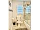 Clean bathroom featuring a shower, toilet, decorative wall accents, and tiled walls at 1122 Spaceport Ct, Kissimmee, FL 34741
