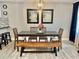 Stylish dining room with a large table, bench seating, and eye-catching wall decor at 1122 Spaceport Ct, Kissimmee, FL 34741