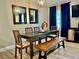 Elegant dining room featuring a modern chandelier, a dining table with seating, and natural lighting at 1122 Spaceport Ct, Kissimmee, FL 34741