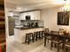 Bright kitchen with stainless steel appliances, sleek black countertops, and a breakfast bar with seating at 1122 Spaceport Ct, Kissimmee, FL 34741