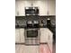 Updated kitchen featuring stainless steel appliances, white cabinets, and a stylish herringbone backsplash at 1122 Spaceport Ct, Kissimmee, FL 34741